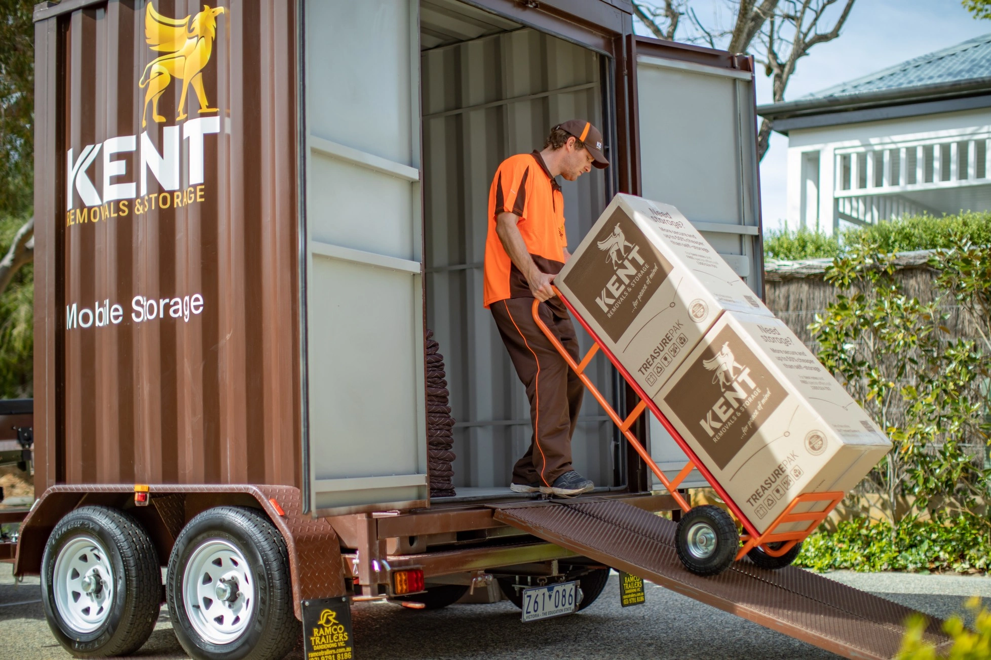 Worker carrying boxes inside storage unit