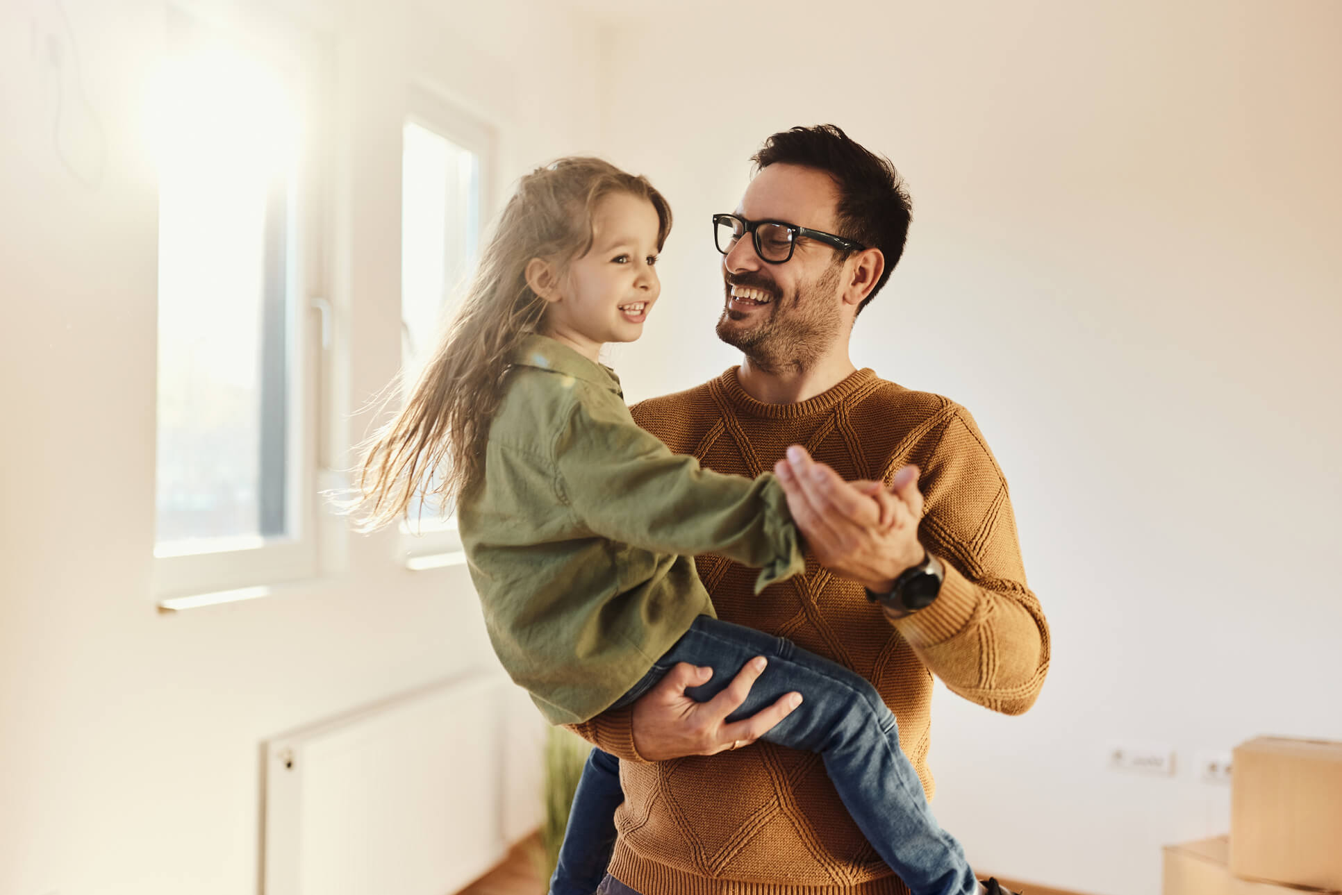 Smiling father holding his daughter